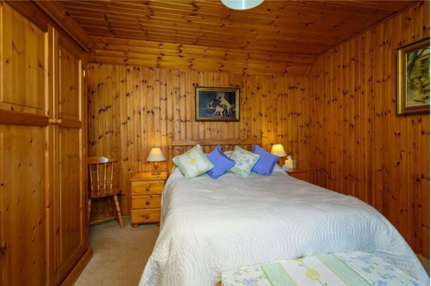 A double bed in the smaller cottage's bedroom