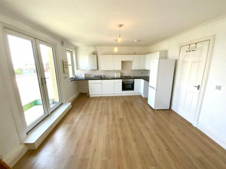 The kitchen with white cabinets.