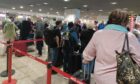 Passengers queuing at Madeira Airport.