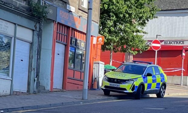 Police at the junction of Hilltown and Rosebank Street after a body was found.