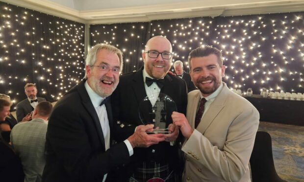 From left: The Courier photographer Kim Cessford, live news editor Bryan Copland and live news reporter James Simpson collect the award for Best Coverage of a Live Event. Image: Supplied.