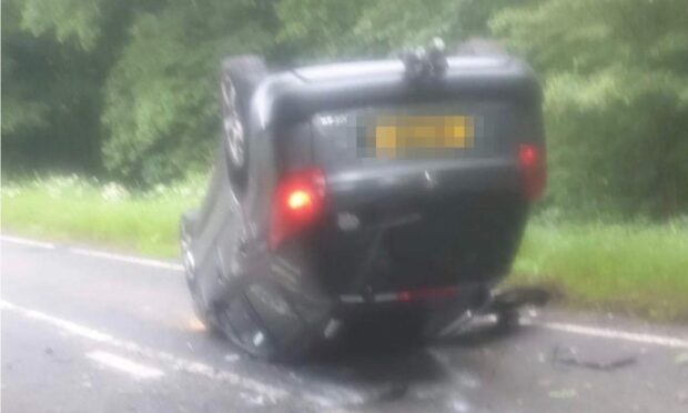 The car on its roof on the A921 between Aberdour and Burntisland.
