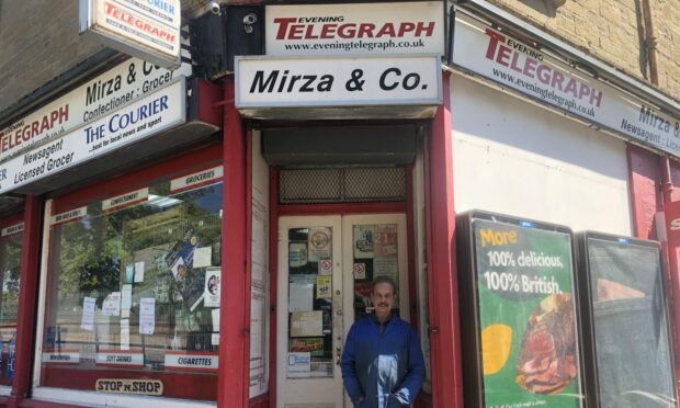 Owner, Khalid Mirza outside his store. Image: James Simpson/DC Thomson