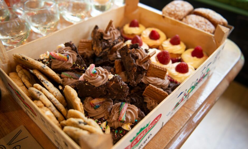 A box of different vegan bakes, like cookies, brownies and muffins.