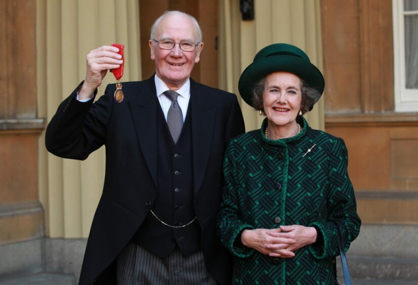 Sir Menzies Campbell holds his medal, with his wife Lady Elspeth Campbell after being made a Companion of Honour. 