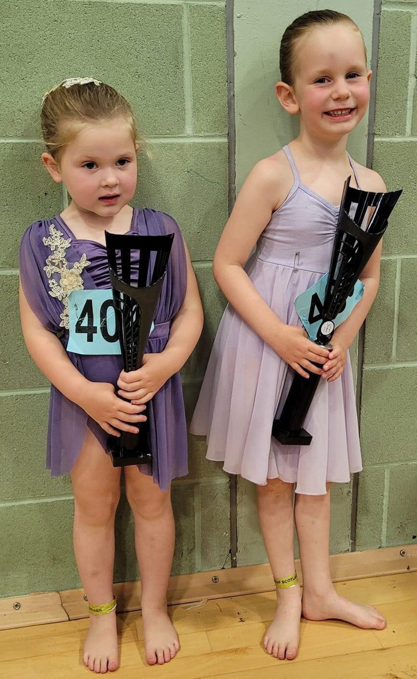 Stella Garvie and Millie Don holding the trophies they won.