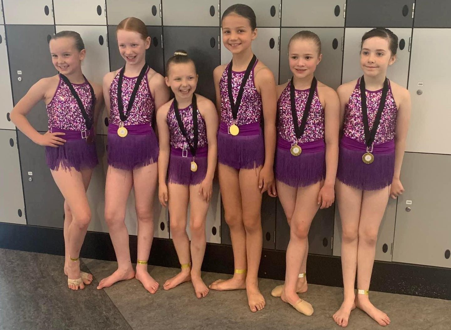 The junior jazz team at Perth's Inspire Dance Studio wearing medals.