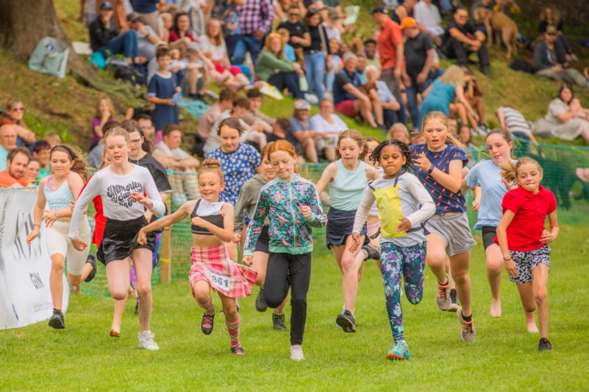 Young girls race to the finish line.