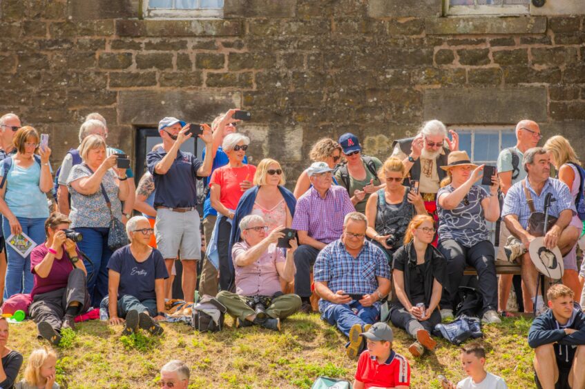 Spectators photographing the event. 