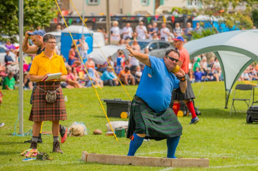 Man taking part in the shot putt.