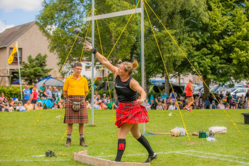 Woman competes in the shot putt event.