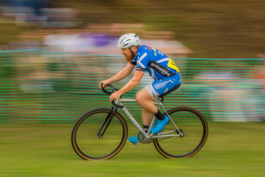 Man cycling at event.