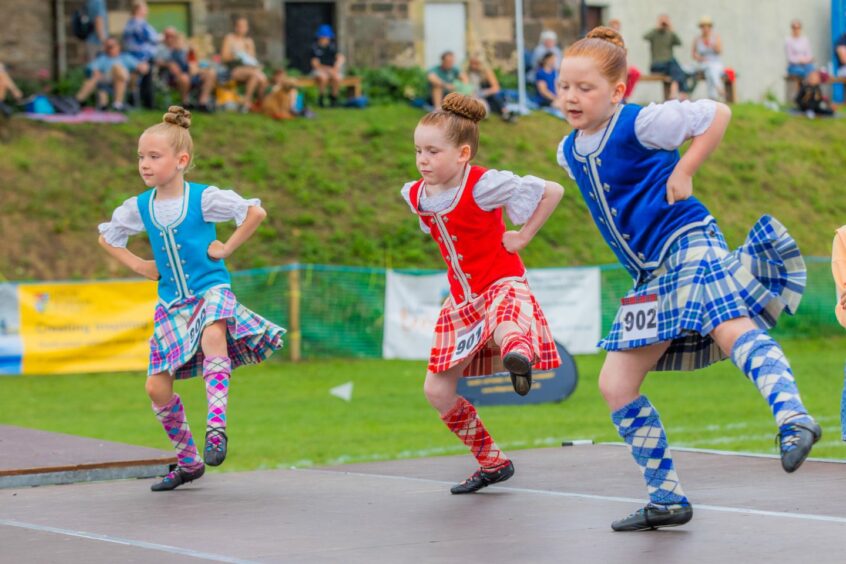 Three young highland dancers.