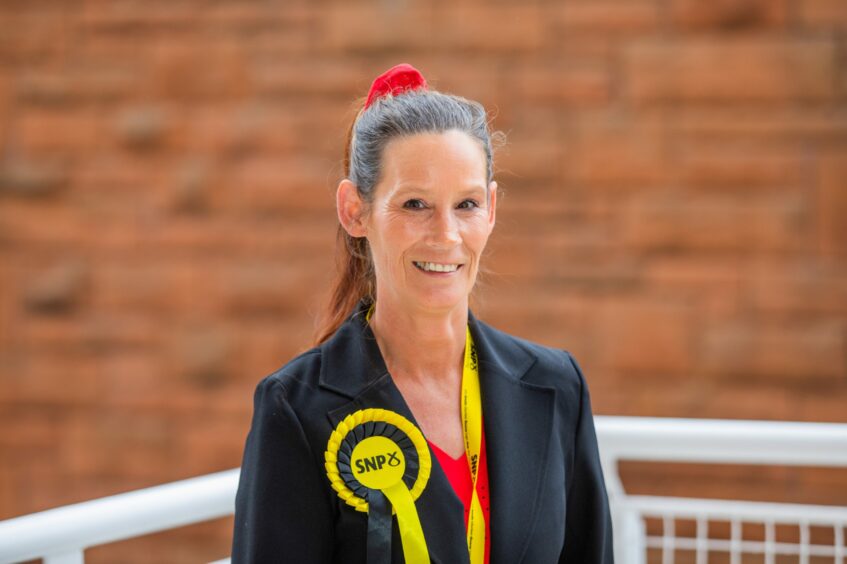 Councillor MIchelle Frampton wearing yellow and black SNP rosette