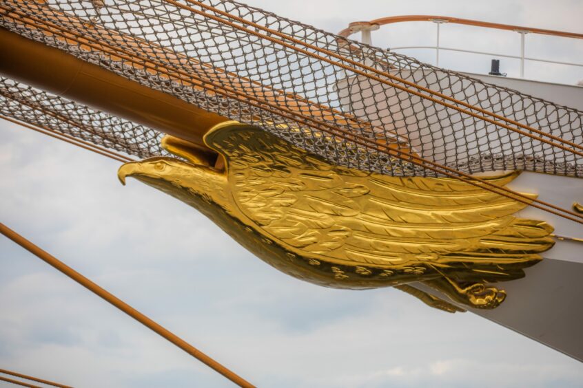 Intricate golden bird detailing on the exterior of the ship.
