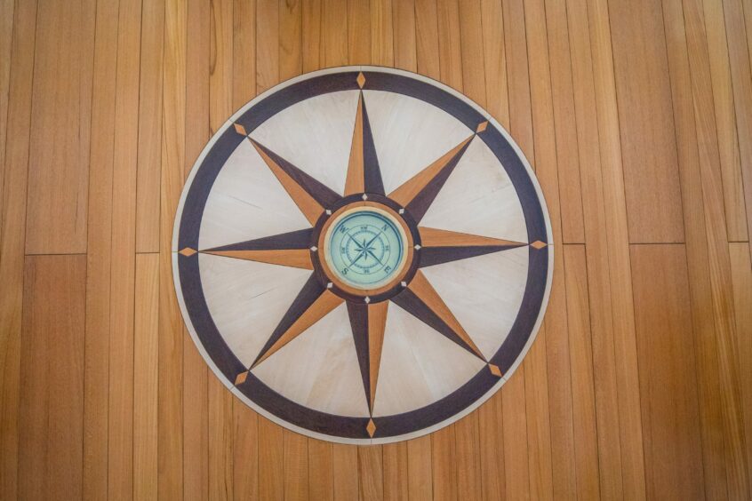 Compass motif in the wooden flooring of the Sea Cloud Spirit's library.