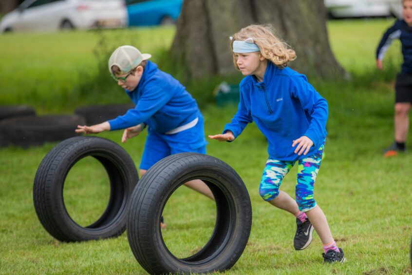Tyre rolling at Strathmore junior highland games at Glamis Castle.
