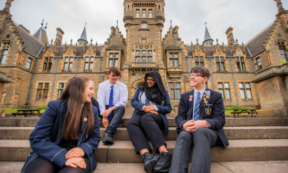 Morgan Academy pupils Katya Walls, Crawford Miller, Imaan Hussain and Lewis Brown in school uniform seated on the school steps as part of a Courier feature about the prevalence of vaping among their peers.