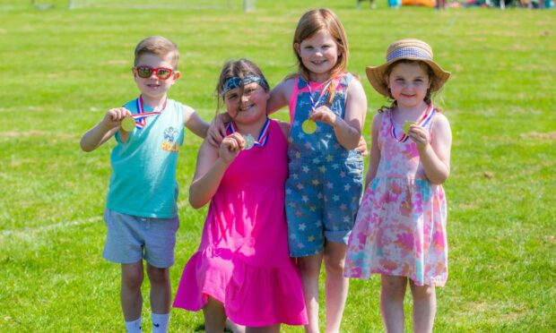 Olly Finlay (6), Ellie Evans (10), Eden Evans (9) and Lucy Millar (5) with their medals at the Kettins fete
