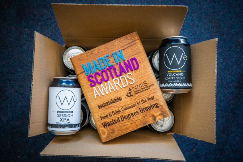A Made in Scotland Awards plaque on top of a box of beer cans.