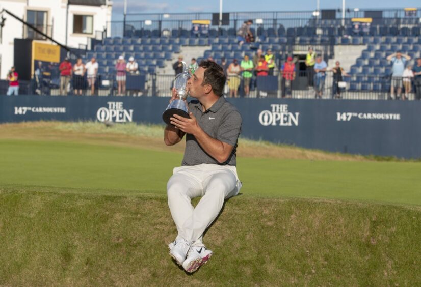 Golfer Francesco Molinari kisses the Claret Jug at Carnoustie Golf Links after winning The Open Championship there in 2018.
