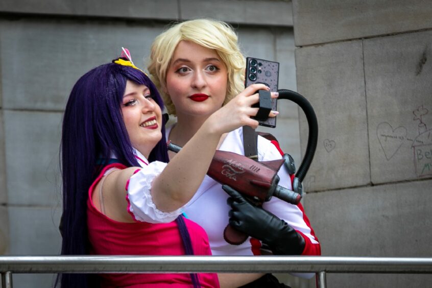 Two friends posefor a selfie.