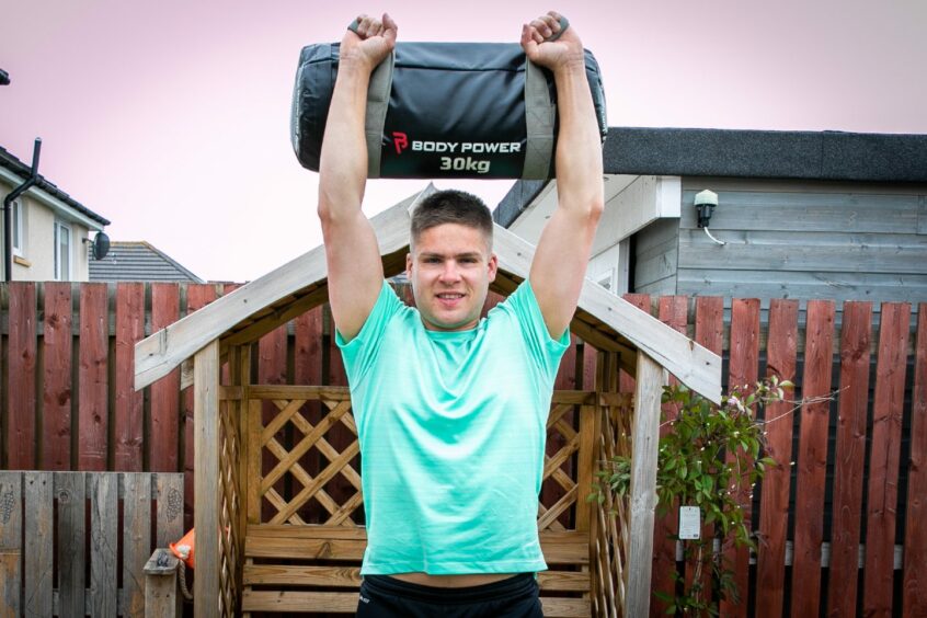 Fitness coach Steven Leslie working out at home in Fife. 