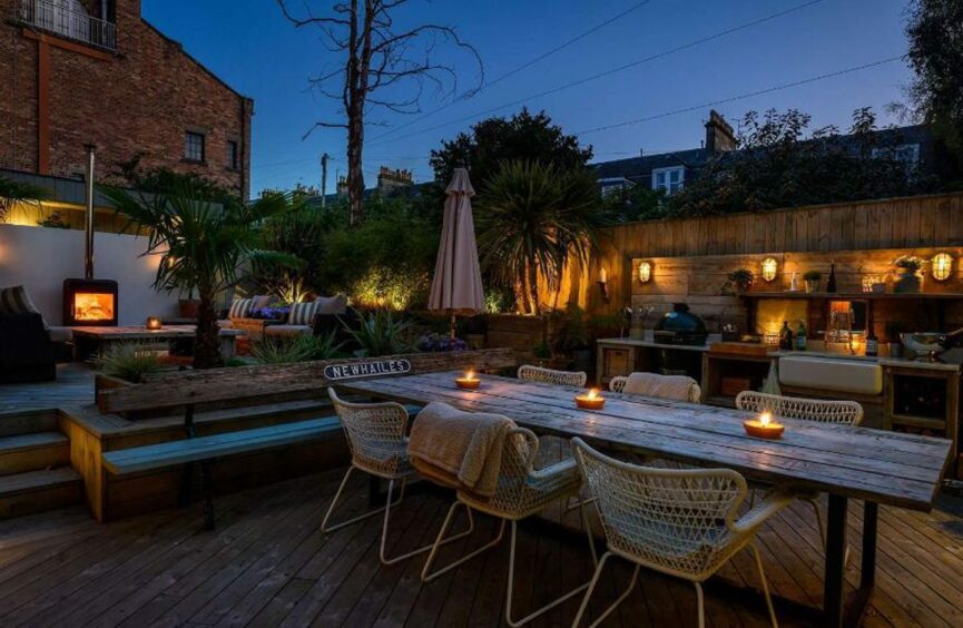 The terrace at the the home on The Scores in St Andrews lit up at night. 