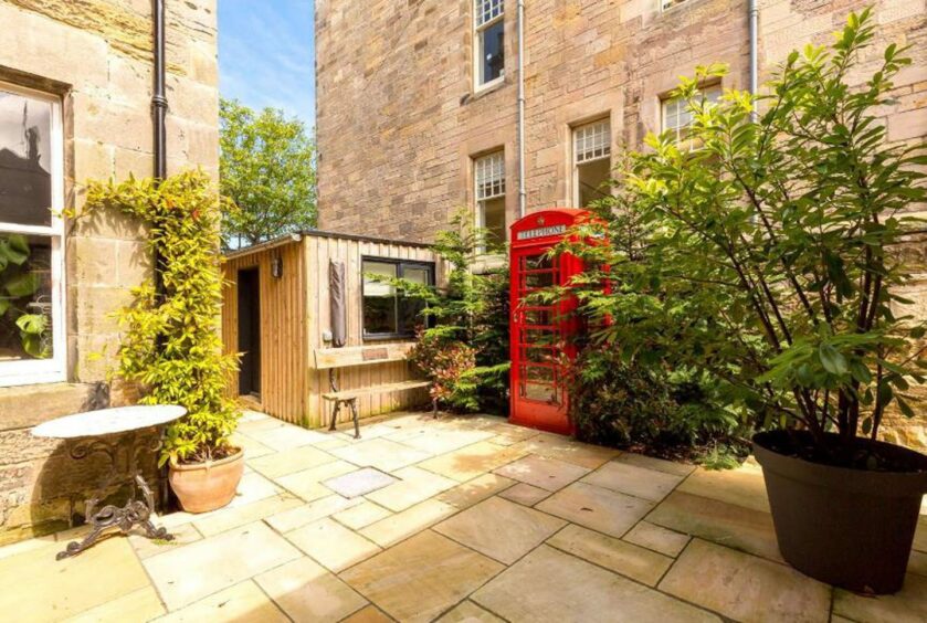 The home on The Scores in St Andrews also has its very own red telephone box. 