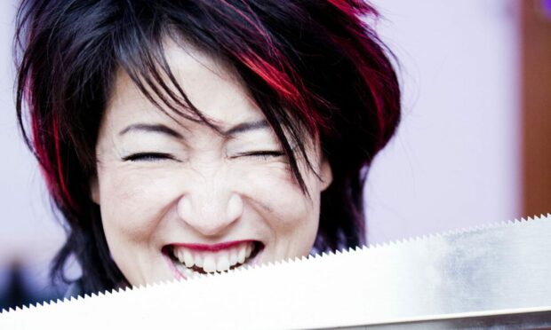Cellist Su-a Lee is pictured biting a musical sword. She will perform at the East Neuk Music Festival this weekend.