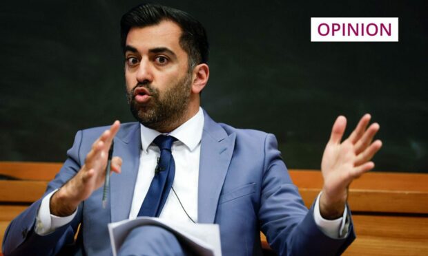 Humza Yousaf speaking on stage at a public event.