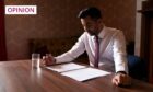 First Minister Humza Yousaf in shirt sleeves, seated at a polished table as he reads through papers in front of him. The image was taken as he prepared for his speech to the SNP independence convention in the Caird Hall, Dundee.