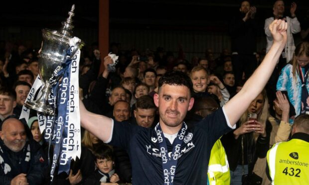 Shaun Byrne hoists the Championship trophy after the Dark Blues sealed promotion last season. Image: SNS