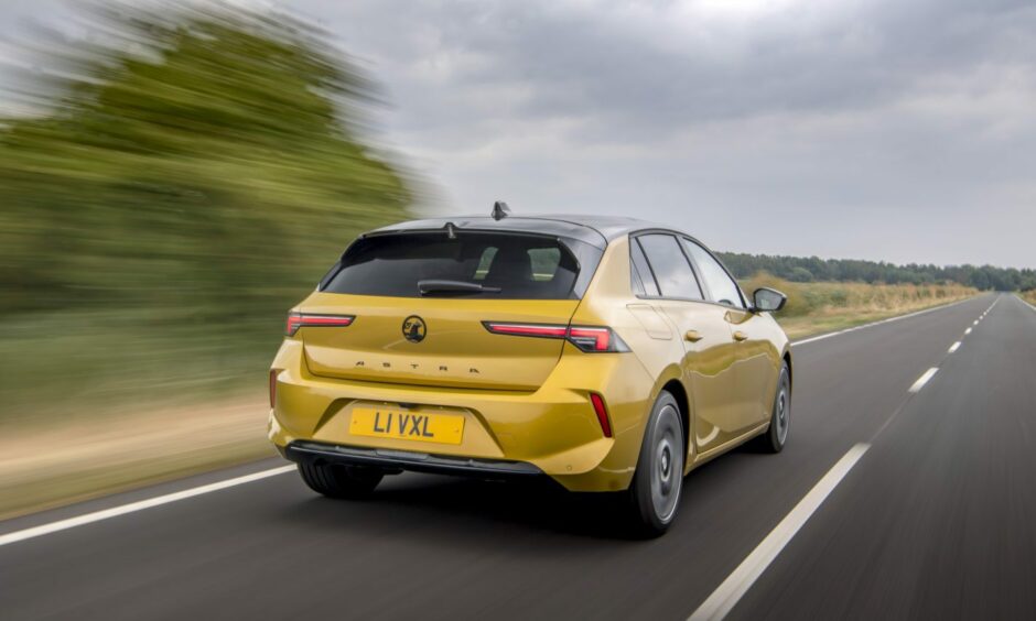The latest Vauxhall Astra seen from the rear with a straight road stretching out in front