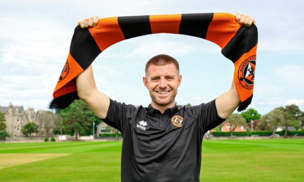 Ross Docherty poses with a Dundee United scarf in St Andrews