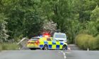 Police block the rural Fife road after the crash.