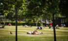 People sunbathing in Slessor Gardens, Dundee, during the mini heatwave.