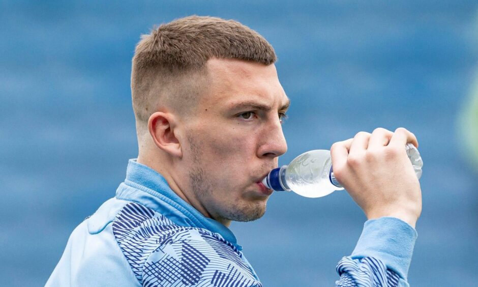 Alex Mitchell drinking out of a water bottle.