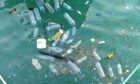 Plastic bottles floating in the sea - millions of bottles could have been captured by the DRS in Scotland
