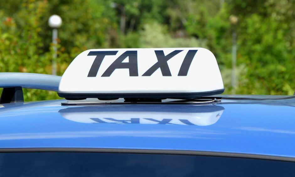 Taxi sign on top of cab