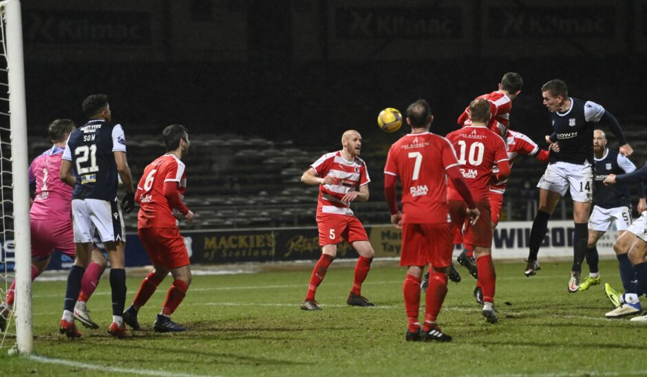 Lee Ashcroft heads in for Dundee at Bonnyrigg Rose in 2021. Image: SNS