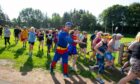Superman Graeme Russo off to a flyer at the start of the Forfar parkrun. Image: Paul Reid