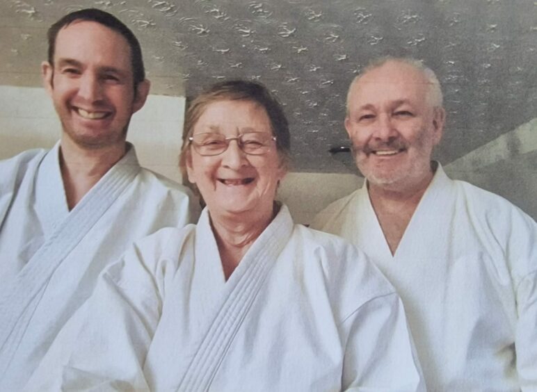 Iain, maureen and Fred Cotterell in karate suits.