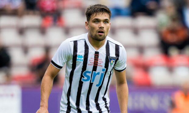 Dunfermline defender Aaron Comrie has his eyes on the action.