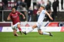 Max Anderson challenges Arbroath's Mark Stowe. Image: SNS