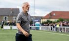 A dejected Dundee United manager Jim Goodwin strides off the field at Ainslie Park