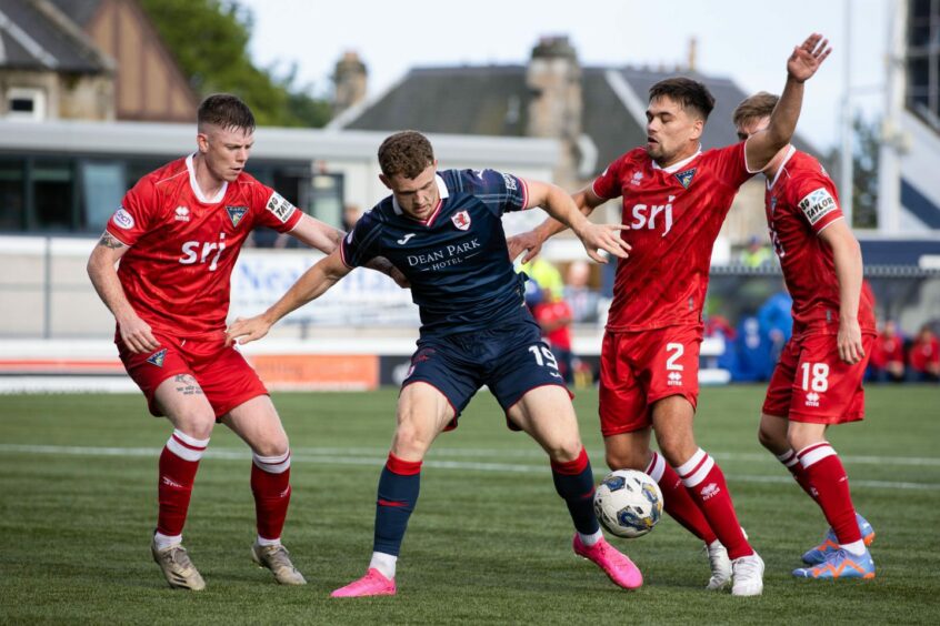 Dunfermline Athletic defenders Sam Fisher and Aaron Comrie tussle with Raith Rovers striker Jack Hamilton in the first Fife derby of the season in July. Image: SNS.