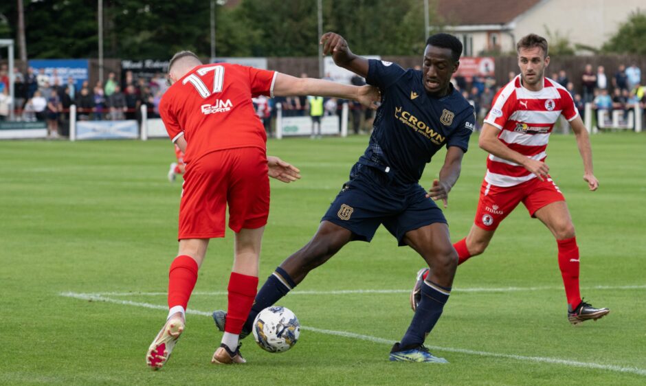 Dundee player Zach Robinson in action.