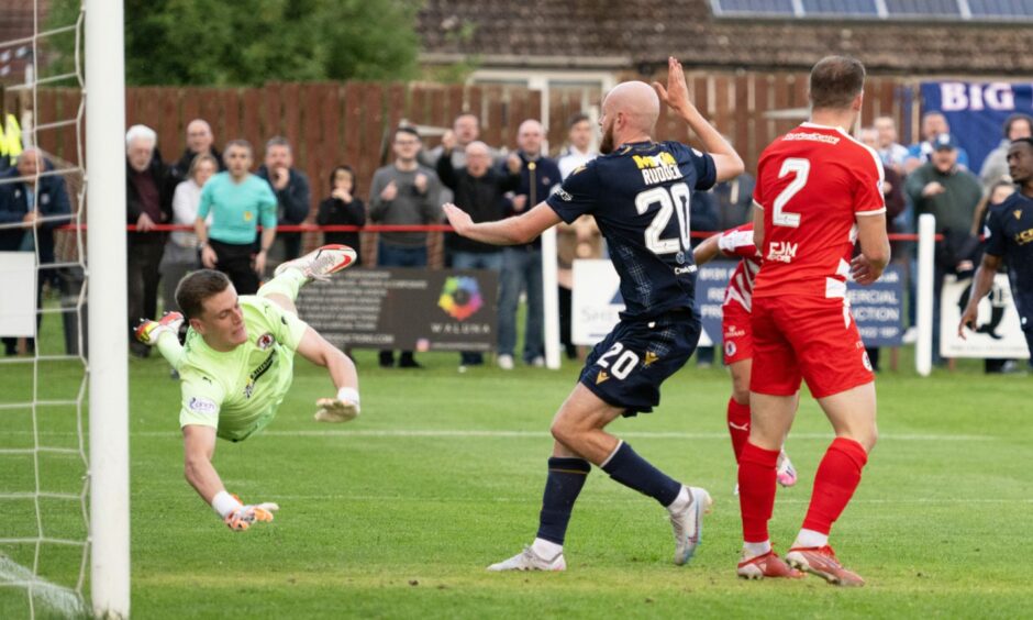 Zak Rudden knocks the ball into the net from close range for Dundee in a game against Bonnyrigg Rose.