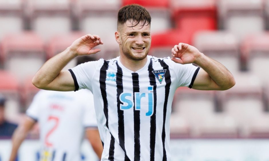 Dunfermline Athletic F.C. defender Josh Edwards stretches his arms during a warm-up.